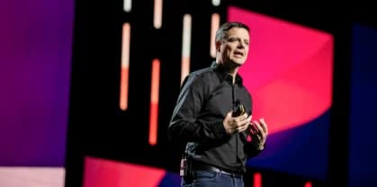 A stylized graphic featuring the word "hi" in vibrant colors, set against a soft, abstract background. The word "workhuman" is displayed in the top left corner, rendered in a clean, modern font.