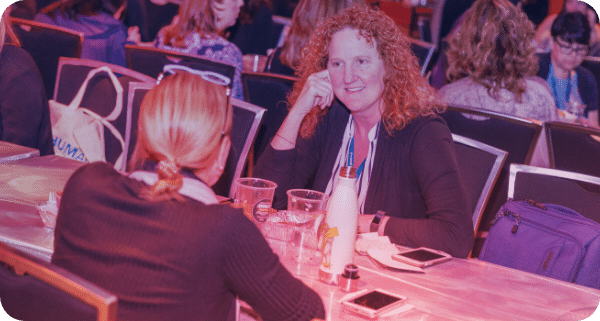 two hr executives at a table connecting during a workshop