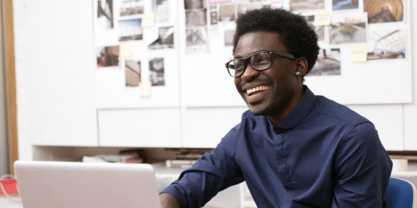 Man smiling at computer screen